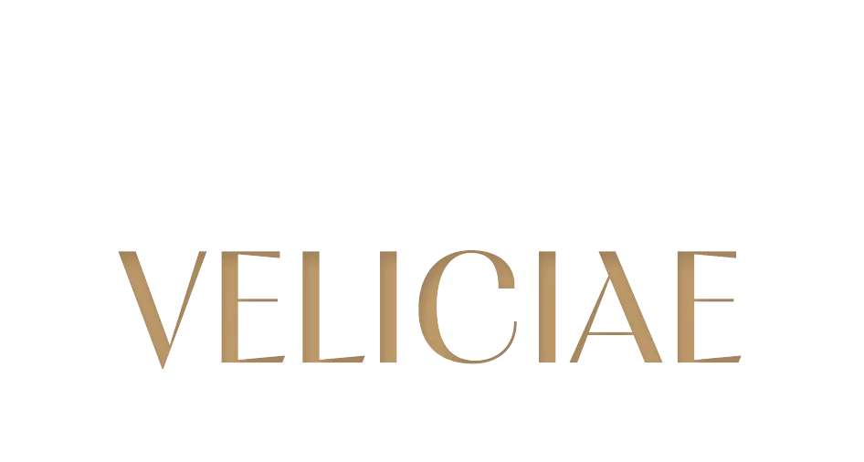The Veliciae Luxury Real Estate logo in white and gold lettering